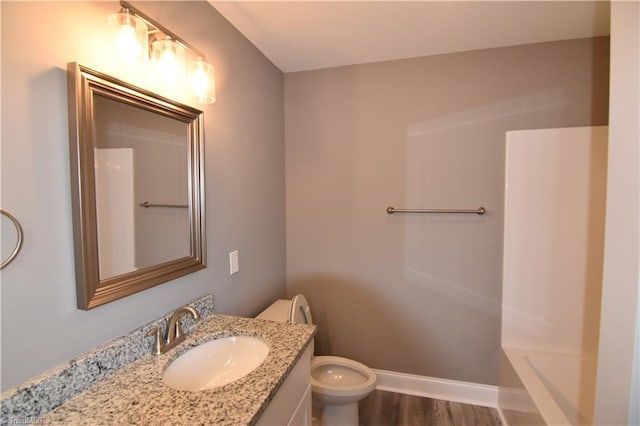 full bath featuring baseboards, vanity, toilet, and wood finished floors