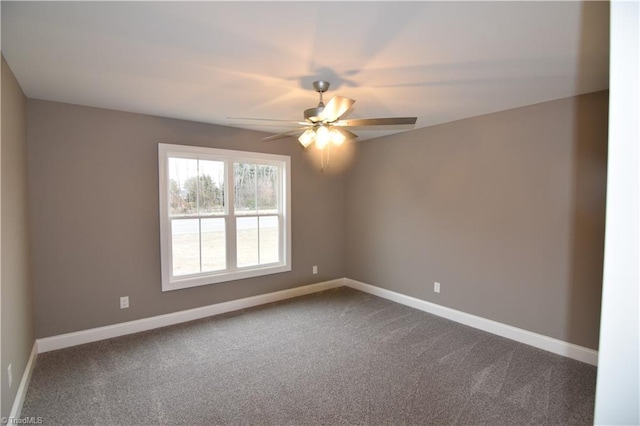 unfurnished room featuring ceiling fan, dark colored carpet, and baseboards