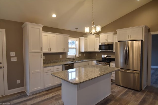 kitchen featuring dark wood-style flooring, lofted ceiling, appliances with stainless steel finishes, white cabinets, and a sink