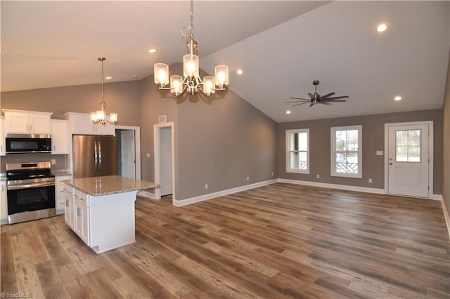 kitchen with a center island, stainless steel appliances, open floor plan, white cabinetry, and wood finished floors