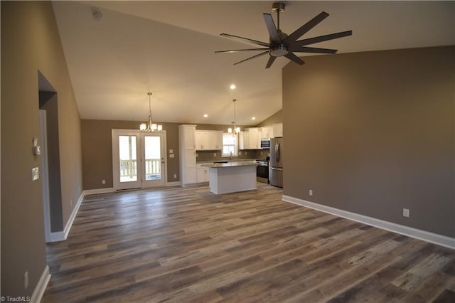 kitchen featuring white cabinets, a kitchen island, open floor plan, stainless steel appliances, and ceiling fan with notable chandelier