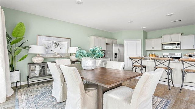 152 Rose Wind Way, Mayodan, NC 27027 - dining space with light wood-style flooring, visible vents, and baseboards