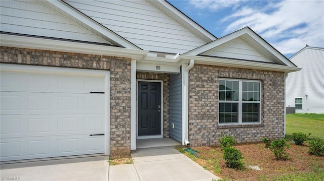 152 Rose Wind Way, Mayodan, NC 27027 - property entrance featuring brick siding and an attached garage