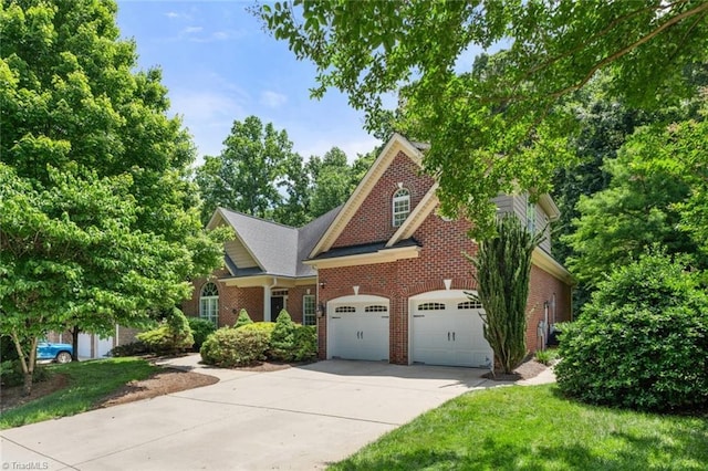 5080 Century Oaks Ln, Winston-Salem, NC 27106 - view of front of property featuring brick siding, driveway, an attached garage, and a front yard