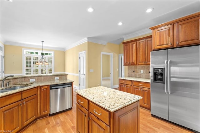 5080 Century Oaks Ln, Winston-Salem, NC 27106 - kitchen with stainless steel appliances, crown molding, brown cabinetry, a sink, and recessed lighting