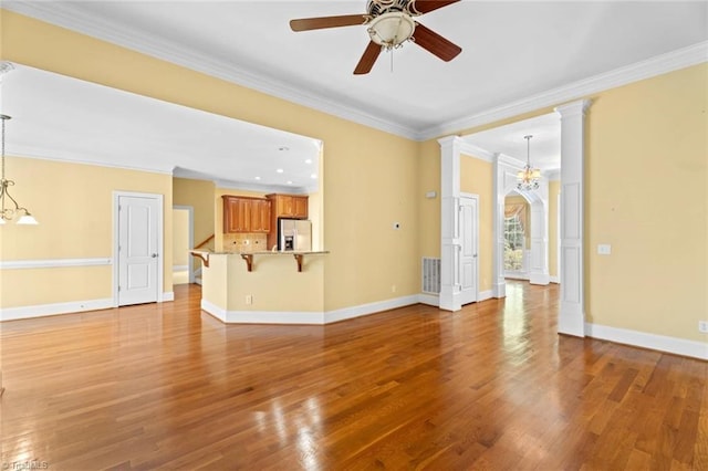 5080 Century Oaks Ln, Winston-Salem, NC 27106 - unfurnished living room featuring ceiling fan, ornamental molding, wood finished floors, and baseboards