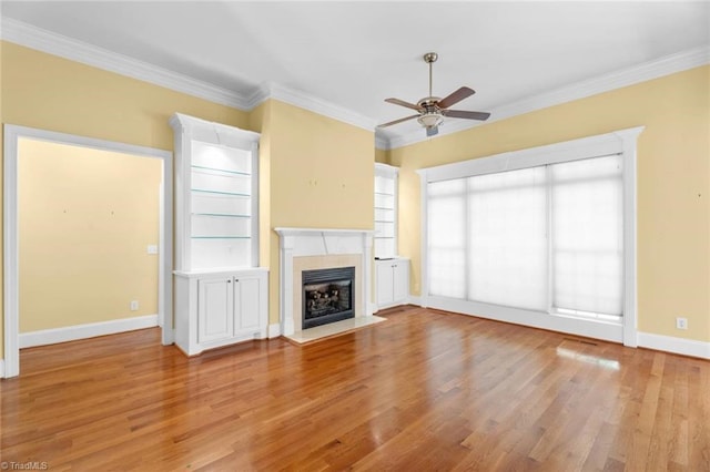 5080 Century Oaks Ln, Winston-Salem, NC 27106 - unfurnished living room with a ceiling fan, light wood finished floors, crown molding, a fireplace with flush hearth, and baseboards