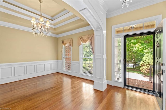 5080 Century Oaks Ln, Winston-Salem, NC 27106 - foyer with a chandelier, crown molding, wood finished floors, a wainscoted wall, and arched walkways