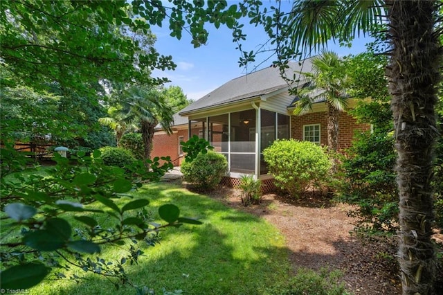 5080 Century Oaks Ln, Winston-Salem, NC 27106 - rear view of property with brick siding, a sunroom, and a lawn