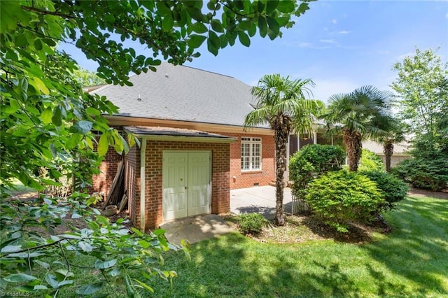 5080 Century Oaks Ln, Winston-Salem, NC 27106 - rear view of property featuring brick siding, a patio, a yard, and a shingled roof