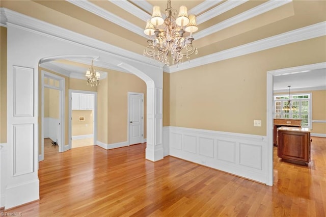 5080 Century Oaks Ln, Winston-Salem, NC 27106 - unfurnished room featuring a chandelier, arched walkways, light wood-style floors, crown molding, and a tray ceiling