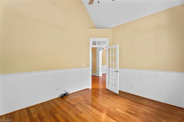 5080 Century Oaks Ln, Winston-Salem, NC 27106 - unfurnished room with wainscoting, vaulted ceiling, wood finished floors, french doors, and a ceiling fan