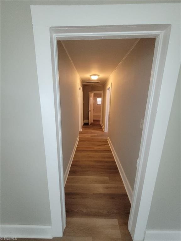 hallway with hardwood / wood-style flooring