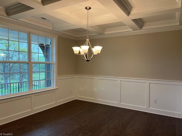 spare room featuring beamed ceiling, ornamental molding, dark hardwood / wood-style floors, a chandelier, and coffered ceiling