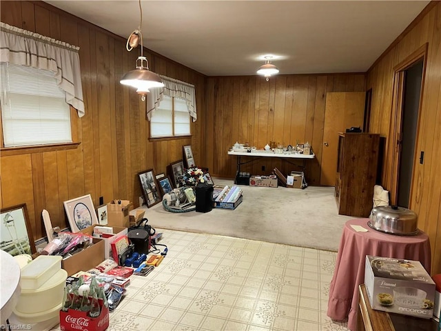 dining room featuring carpet and wooden walls