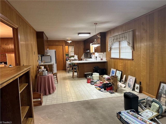 dining room featuring wood walls