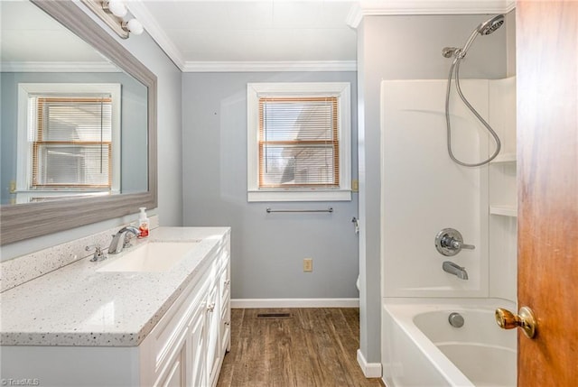 bathroom featuring ornamental molding, vanity, shower / washtub combination, and hardwood / wood-style floors