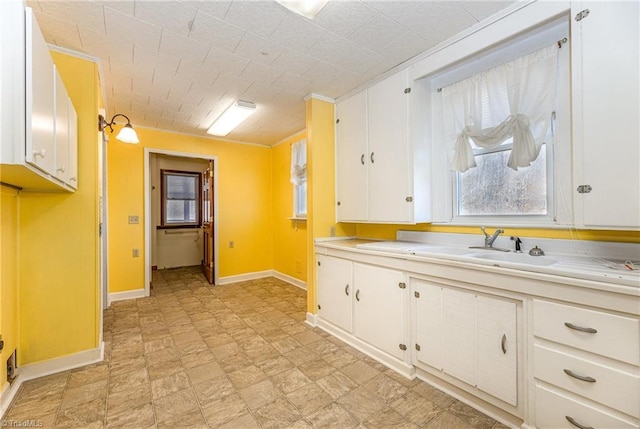 kitchen with white cabinetry and sink