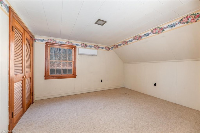 bonus room featuring a wall mounted AC, lofted ceiling, and carpet