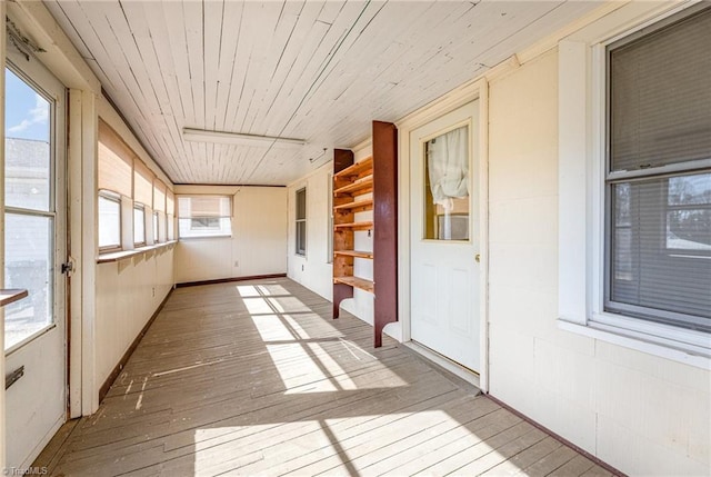 unfurnished sunroom with wood ceiling