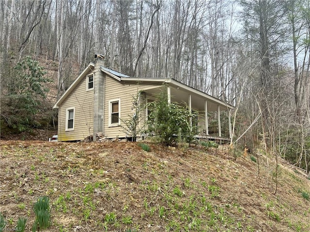 8253 N NC Highway 16, Millers Creek, NC 28651 - view of property exterior with a chimney and a porch