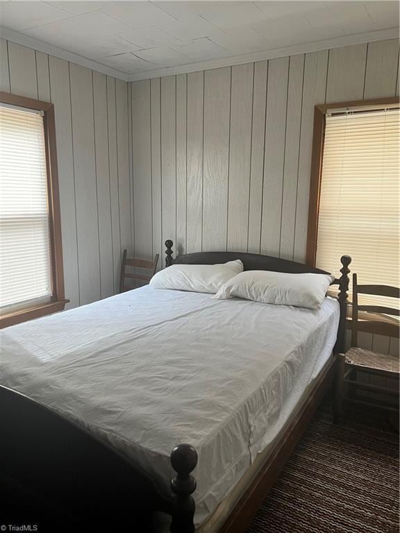 8253 N NC Highway 16, Millers Creek, NC 28651 - bedroom featuring ornamental molding and wood walls