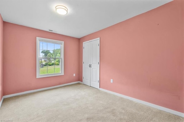 1224 Downing St, High Point, NC 27260 - unfurnished bedroom featuring carpet floors, baseboards, and a closet