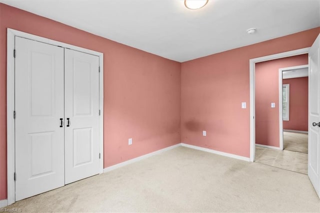 1224 Downing St, High Point, NC 27260 - unfurnished bedroom with light carpet, baseboards, and a closet