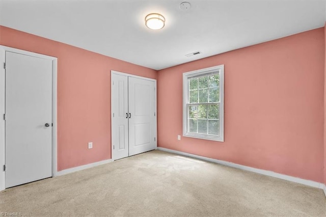 1224 Downing St, High Point, NC 27260 - unfurnished bedroom with carpet, baseboards, and a closet