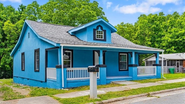 1224 Downing St, High Point, NC 27260 - bungalow featuring a porch, roof with shingles, and stucco siding