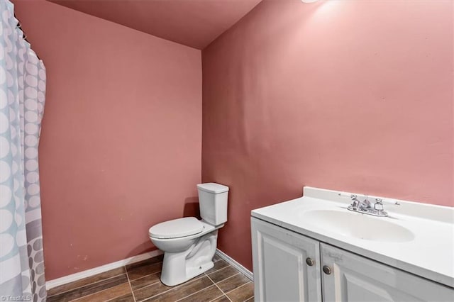 1224 Downing St, High Point, NC 27260 - full bath featuring toilet, vanity, wood tiled floors, and baseboards