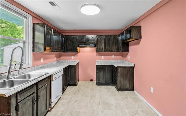 1224 Downing St, High Point, NC 27260 - kitchen featuring dishwasher, a sink, light countertops, and baseboards