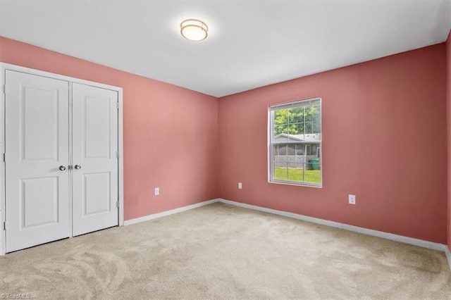 1224 Downing St, High Point, NC 27260 - unfurnished bedroom with carpet flooring, baseboards, and a closet