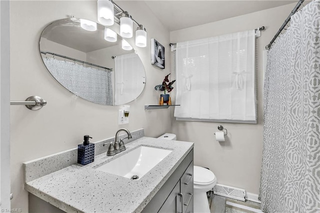 615 Sherman St, Greensboro, NC 27410 - full bathroom with vanity, toilet, and baseboards