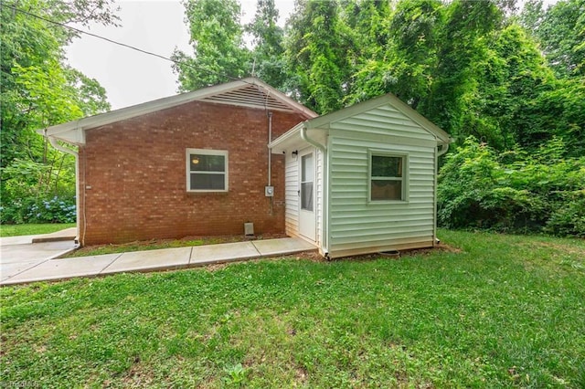 615 Sherman St, Greensboro, NC 27410 - rear view of property with a lawn and brick siding