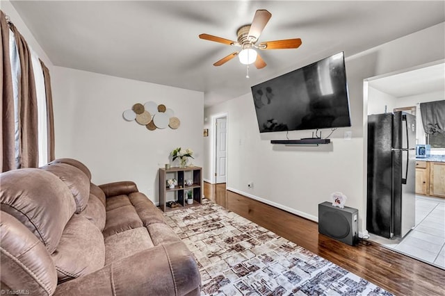 615 Sherman St, Greensboro, NC 27410 - living room with a ceiling fan, light wood-style flooring, and baseboards