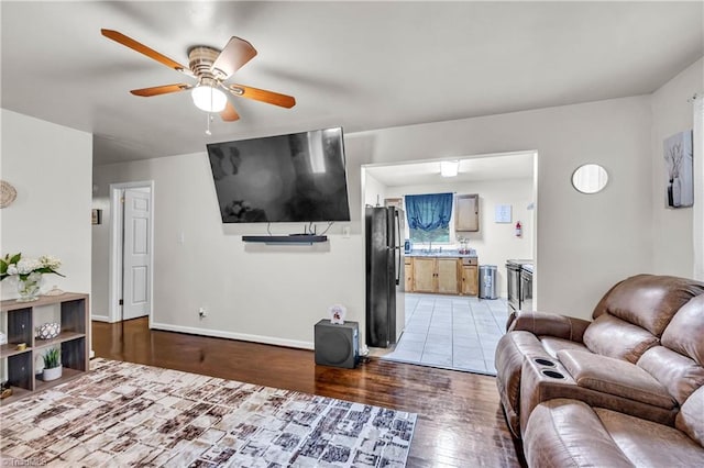 615 Sherman St, Greensboro, NC 27410 - living room with wood finished floors, a ceiling fan, and baseboards