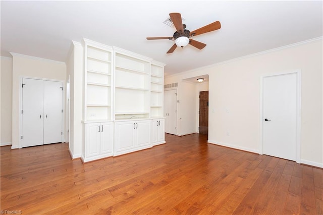 unfurnished living room featuring ceiling fan, ornamental molding, and hardwood / wood-style floors