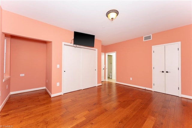 unfurnished bedroom featuring hardwood / wood-style flooring