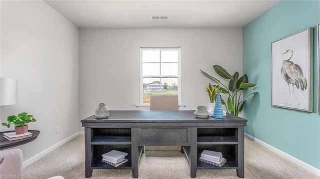 carpeted home office featuring visible vents and baseboards