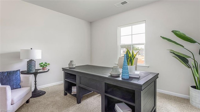 office featuring baseboards, visible vents, and light colored carpet