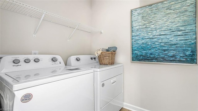 laundry room featuring laundry area, independent washer and dryer, and baseboards