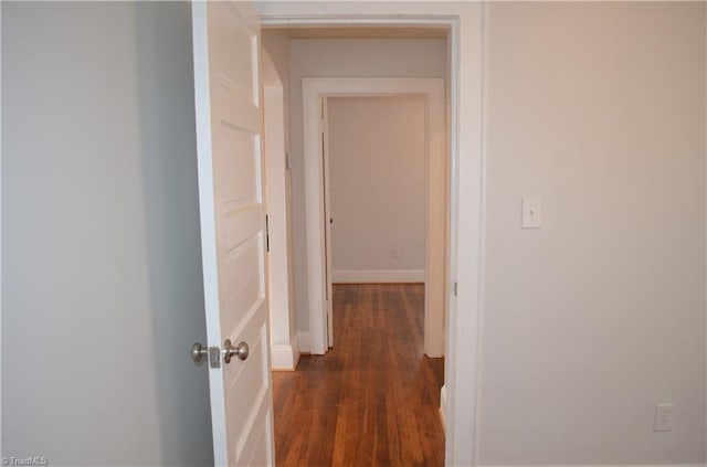 corridor with dark wood-style floors
