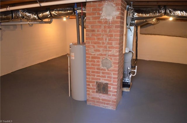 unfinished basement featuring gas water heater