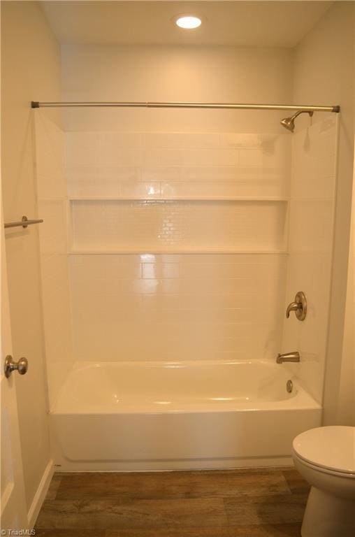 full bathroom featuring toilet, shower / bath combination, and wood finished floors