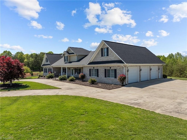 view of front of property featuring an attached garage, driveway, and a front lawn