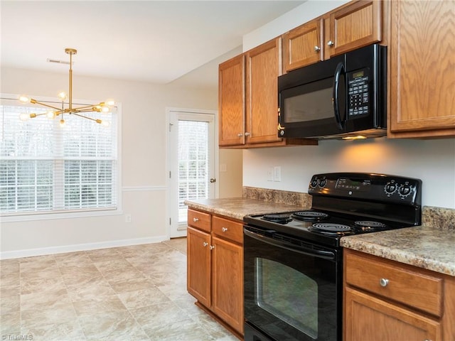 kitchen featuring hanging light fixtures, an inviting chandelier, and black appliances