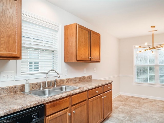 kitchen featuring sink, a notable chandelier, hanging light fixtures, and dishwasher