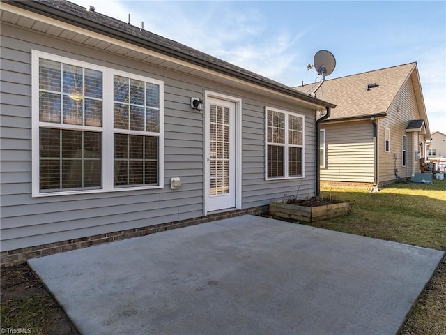 back of property with a yard and a patio