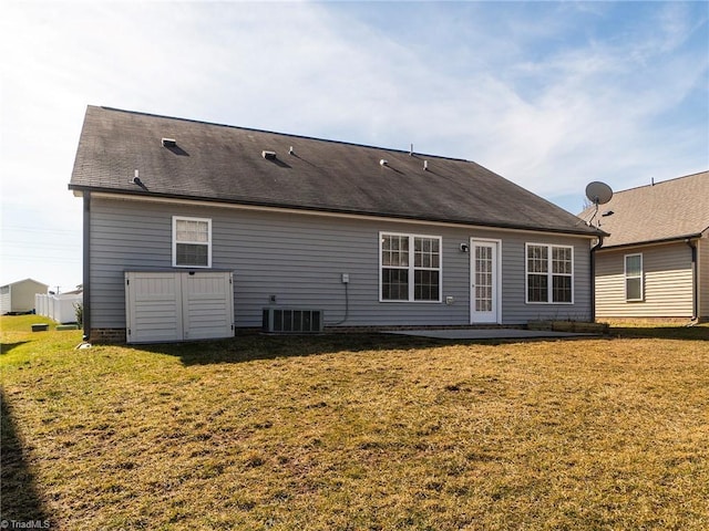 back of house featuring cooling unit, a lawn, and a patio